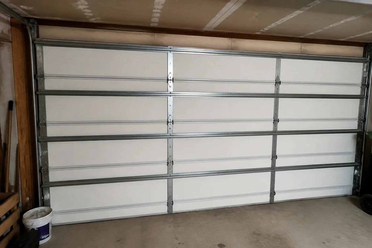 Interior of a closed sectional door with horizontal metal reinforcement struts.